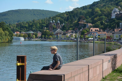 Boy  looking at river in miltenberg, germany 