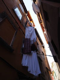 Low angle view of clothes drying on balcony of building