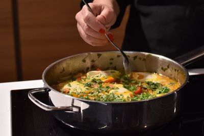 Close-up of hand holding salad in bowl