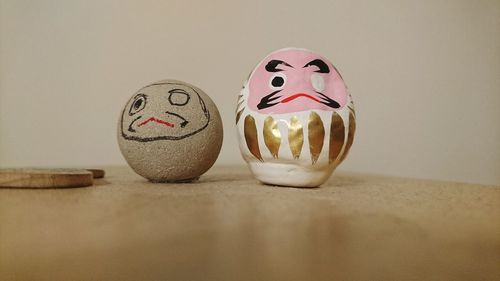 Close-up of anthropomorphic face on stones at table