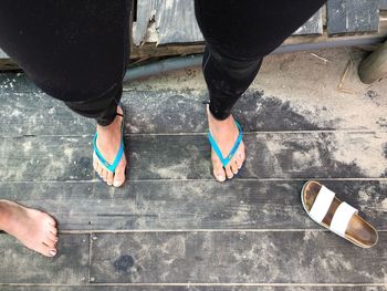 Low section of people standing on tiled floor