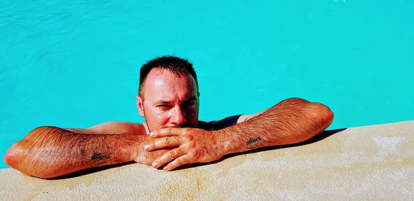 Portrait of shirtless man in swimming pool