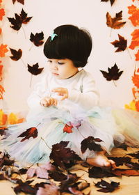 Rear view of woman looking at autumn leaves