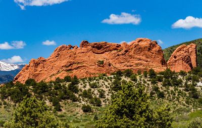 Rock formations on landscape against blue sky
