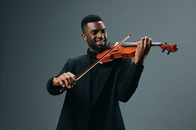 Man playing violin against white background