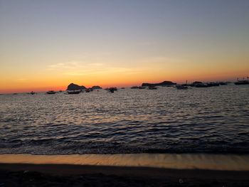 Scenic view of sea against clear sky during sunset