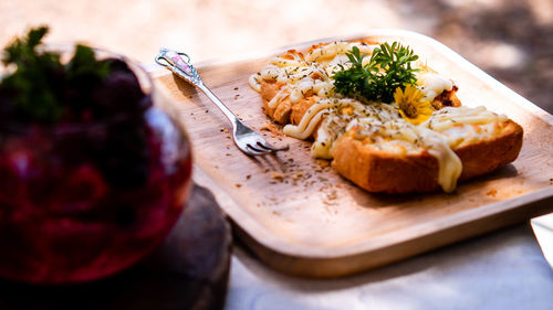 Slice of toasted white bread spread with mayonnaise decorate on top with flower and vegetable.