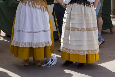 Low section of people standing on street