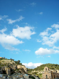 Buildings against blue sky and clouds