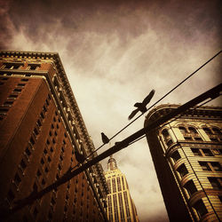 Low angle view of building against cloudy sky