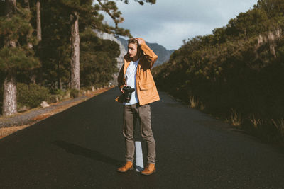 Rear view of woman walking on road