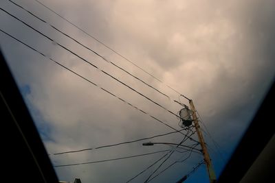 Low angle view of electricity pylon against sky