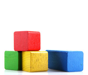 Close-up of multi colored wooden blocks against white background