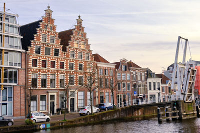 Gravestenen drawbridge raised over spaarne river with gable canal houses. haarlem, the netherlands.