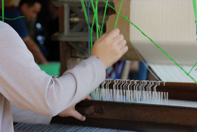 Midsection of person playing piano