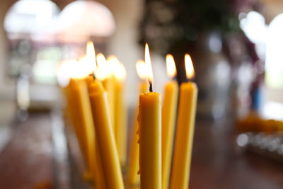 Close-up of lit candles in temple