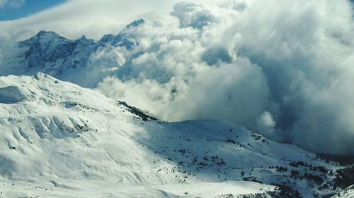 Scenic view of snowcapped mountains against sky