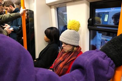 Rear view of people sitting in train