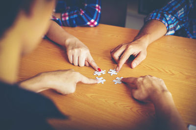 High angle view of people playing on table