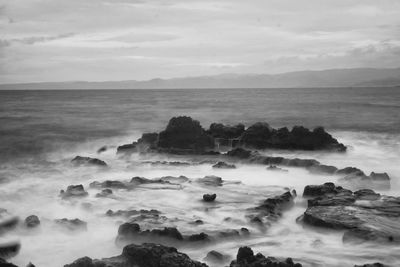 Scenic view of sea against cloudy sky