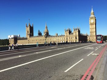 View of buildings in city against blue sky