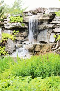 Scenic view of waterfall against sky