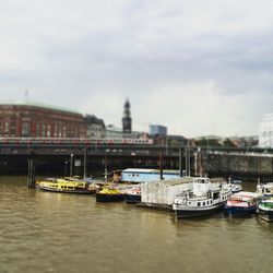 Boats in river with city in background