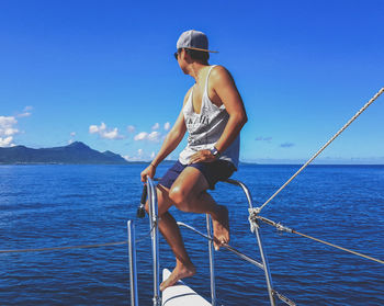 Man on sailboat against sea against sky