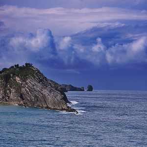 Scenic view of sea against cloudy sky