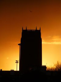 Silhouette of building at sunset