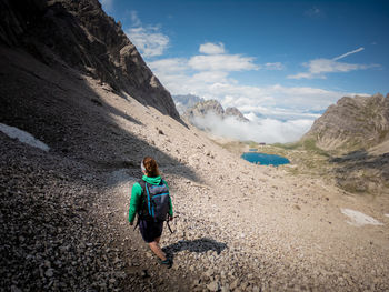 Rear view of woman walking on mountain