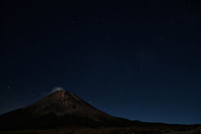 Scenic view of mountain against sky at night