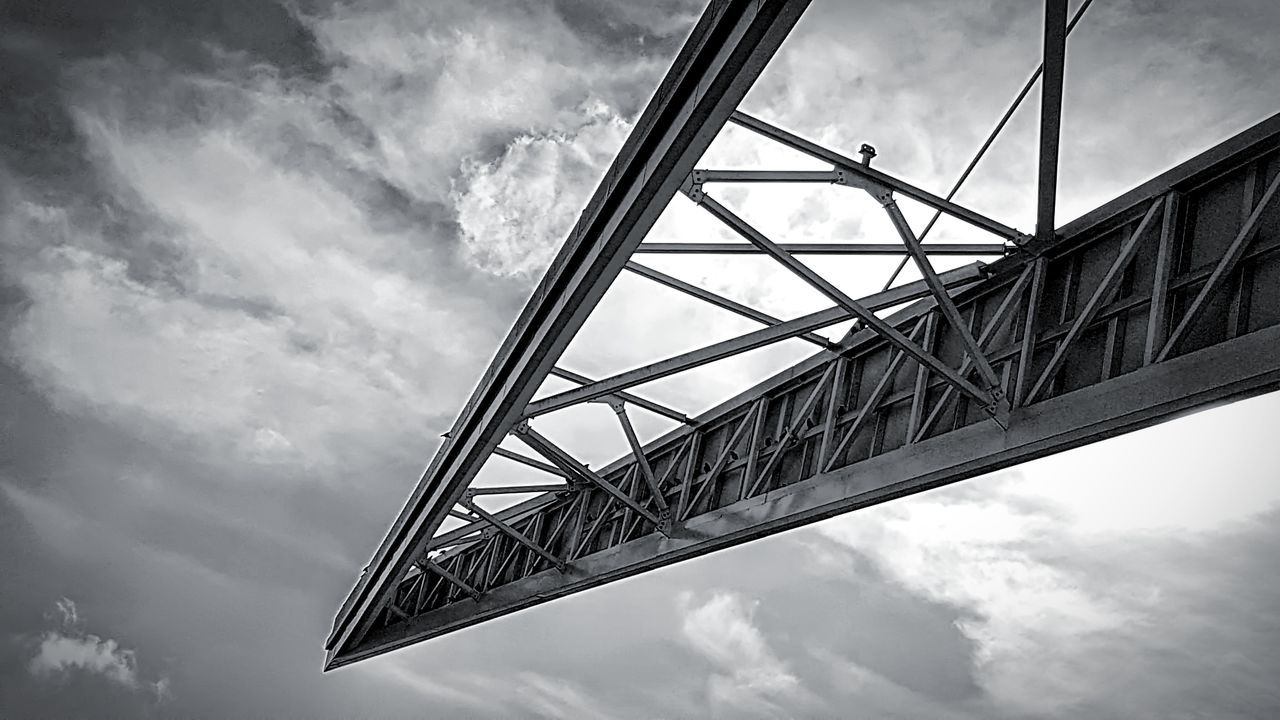 cloud - sky, sky, low angle view, built structure, architecture, nature, bridge, no people, connection, day, bridge - man made structure, transportation, metal, outdoors, overcast, travel, city, building exterior, place