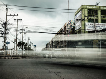 Train on railroad tracks in city against sky