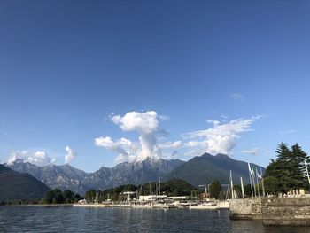 Scenic view of lake and mountains against blue sky