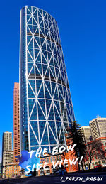 Low angle view of modern building against blue sky