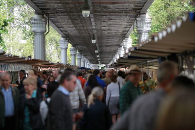 People at market under bridge