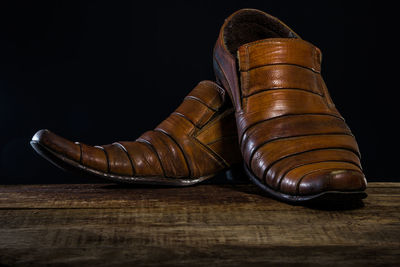 Close-up of shoes on wooden floor