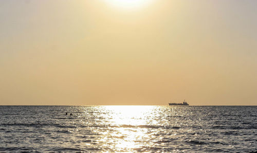 Scenic view of sea against clear sky during sunset