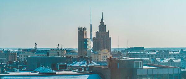 Buildings in city against clear sky