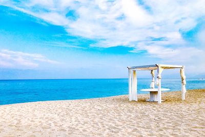 Lifeguard hut on beach against sky