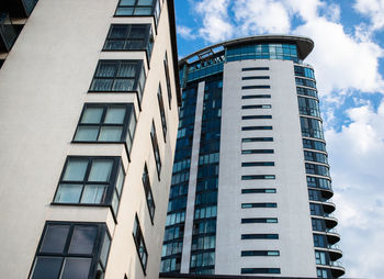 Low angle view of modern building against blue sky