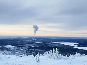 Snow covered landscape against sky