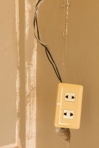 Close-up of telephone booth against wall