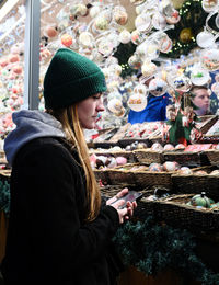 Rear view of woman standing in market