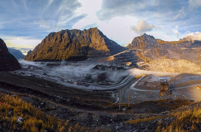 Panoramic view of land and mountains against sky