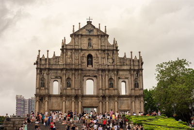 Group of people in temple against sky