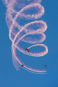 Low angle view of airshow against sky