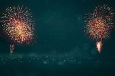 Low angle view of firework display at night