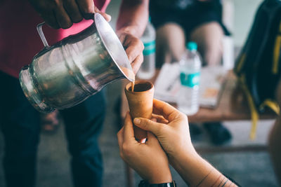 Cropped image of man holding hands